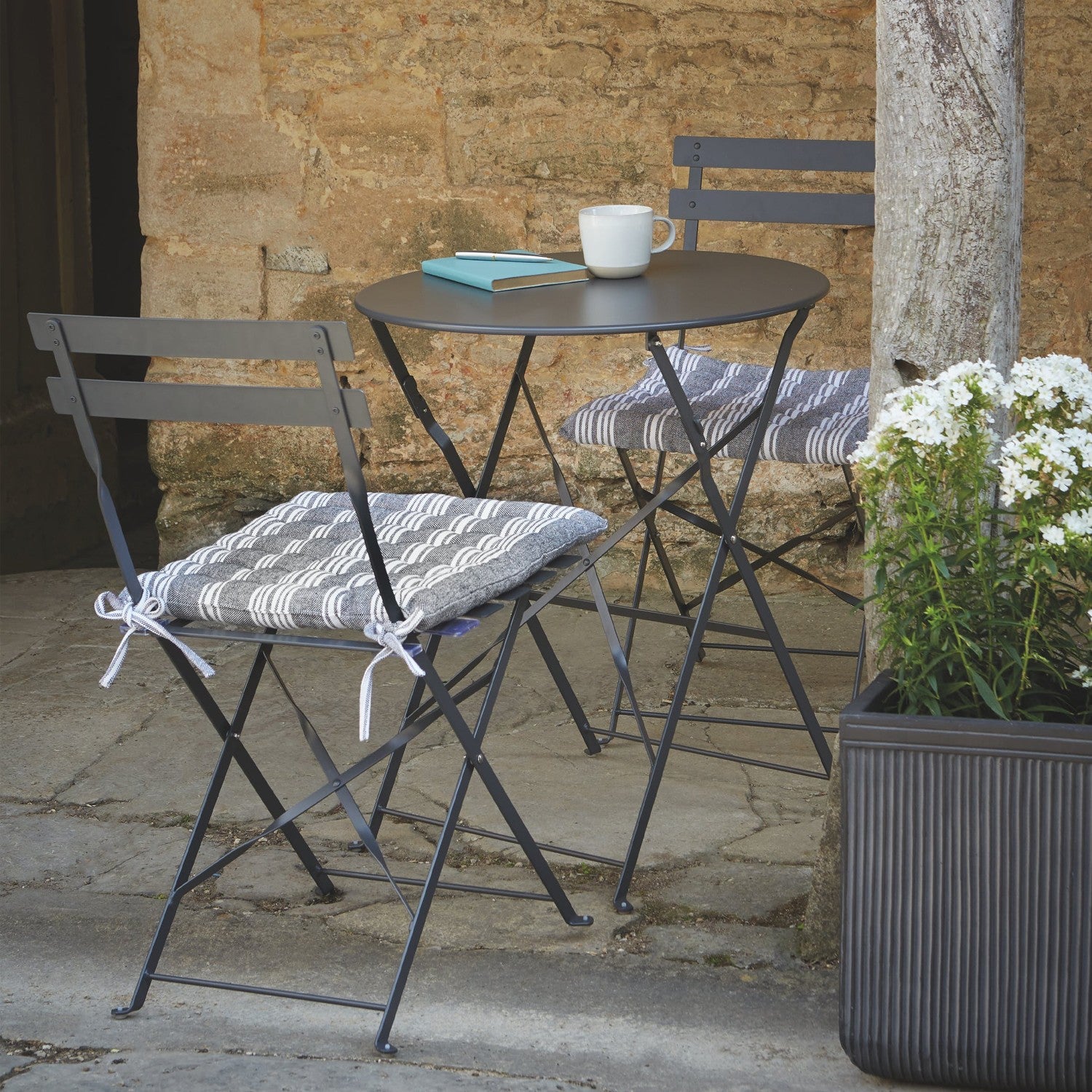 small garden table and two chairs for outdoor dining