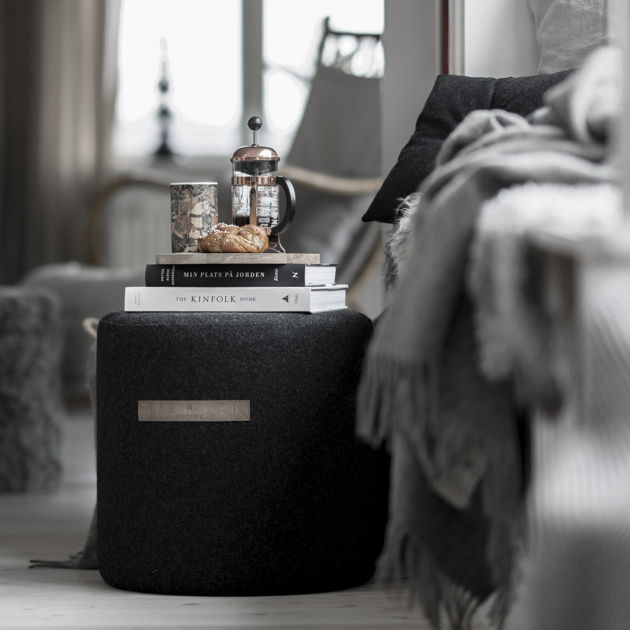 small black wool pouffe from sweden