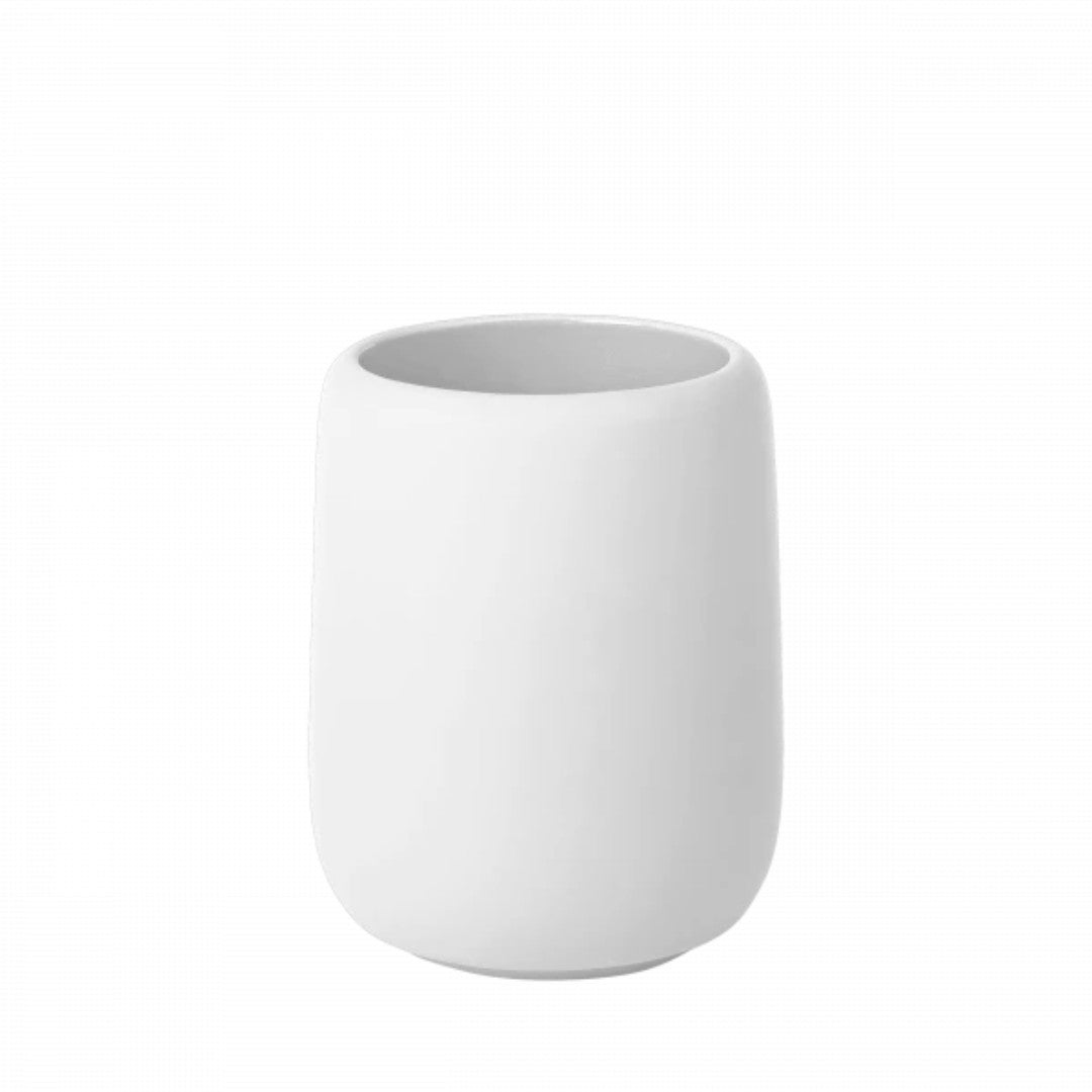 white tumbler for toothbrushes in bathroom