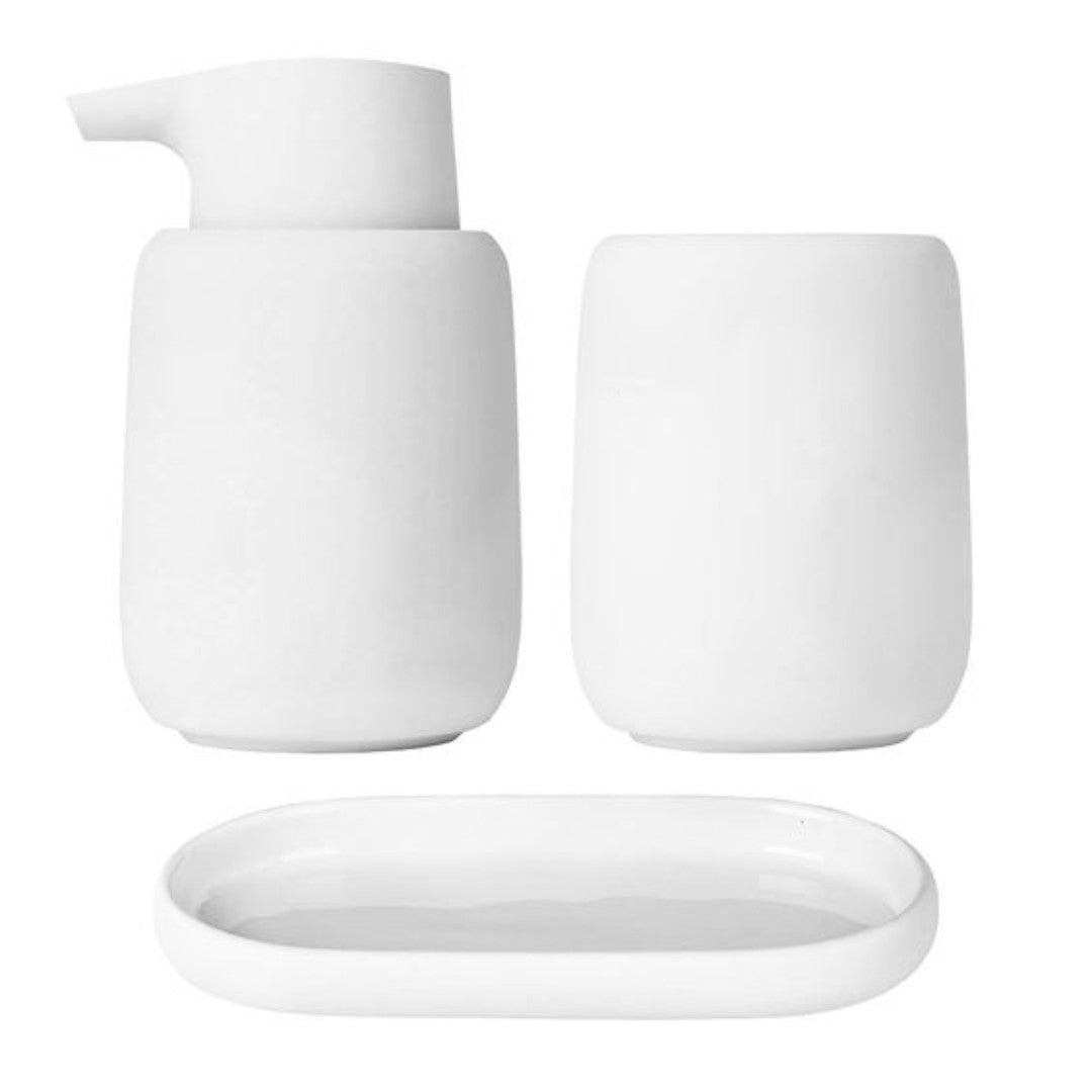 white tumbler for toothbrushes in bathroom