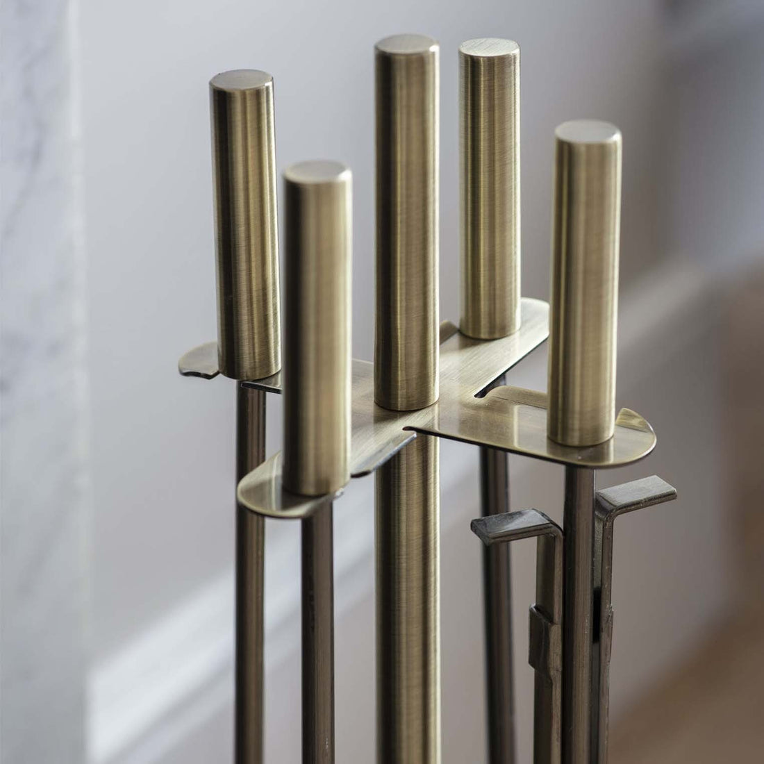 handles and top of antique brass fireside tool set